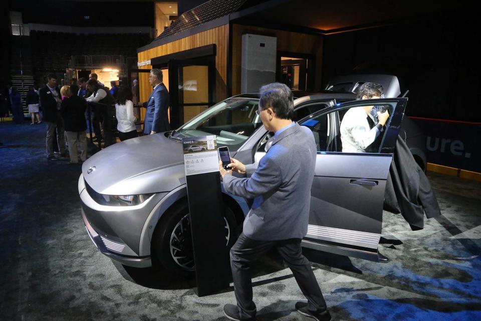 A man takes a photo of the IONIQ 5 on Tuesday October 25, 2022 during the Hyundai community celebration at the enmarket Arena.