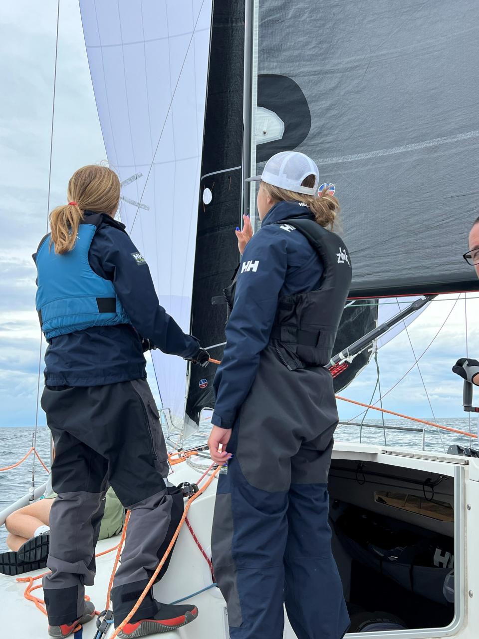 Evelyn Young, 16, of Grosse Pointe, left, and Addie Kimmel, 16, of Grosse Pointe Farms, adjust sails on Diablo on July 15, 2023 during their first Bayview Mackinac race.