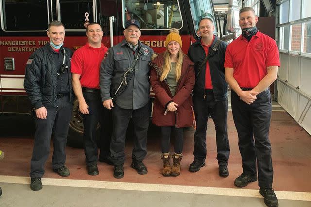 <p>Tenley Gillett</p> Tenley Gillett with members of the Manchester Fire Department in 2021.