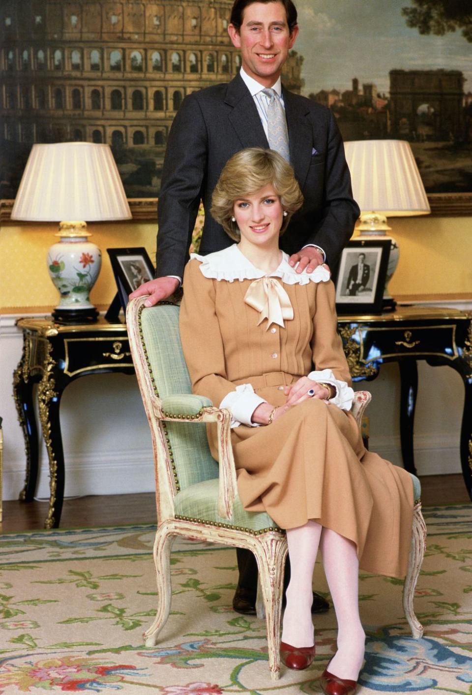 <p>Princess Diana and Prince Charles situate themselves for a picture at home in Kensington Palace. </p>