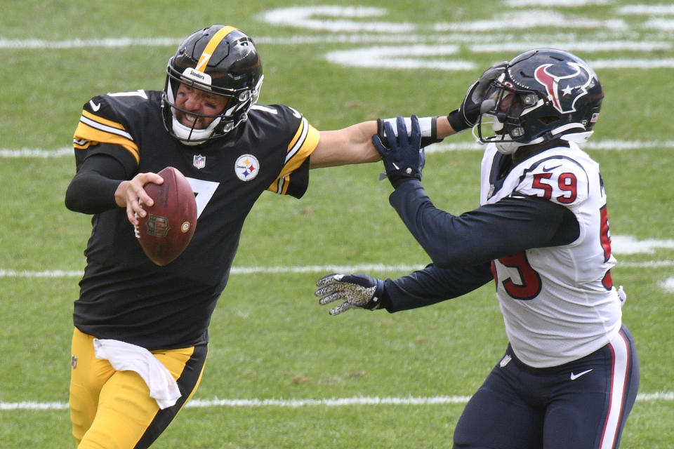 Pittsburgh Steelers quarterback Ben Roethlisberger (7) stiff-arms Houston Texans outside linebacker Whitney Mercilus (59) while trying to scramble for a first down in the second half of an NFL football game, Sunday, Sept. 27, 2020, in Pittsburgh. The Steelers did not get the first down. (AP Photo/Don Wright)