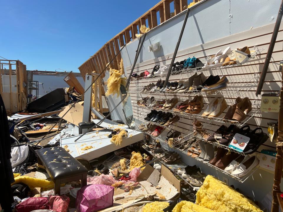 A rack of shoes hangs on the wall at a women's boutique clothing store in Englewood. Hurricane Ian ripped the roof of the store completely off, leaving nothing but blue sky overhead.