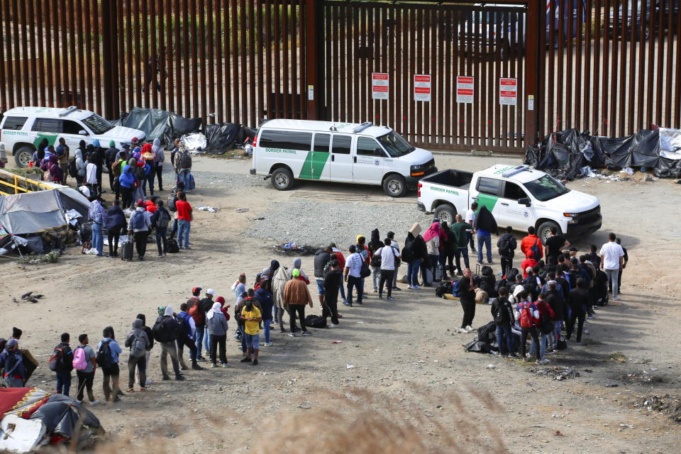 Migrants gather between the primary and secondary border fences in San Diego as the United States prepares to lift COVID-19-era restrictions known as Title 42, that have blocked migrants at the U.S.- Mexico border from seeking asylum since 2020, as seen from Tijuana, Mexico May 8, 2023. REUTERS/Jorge Duenes