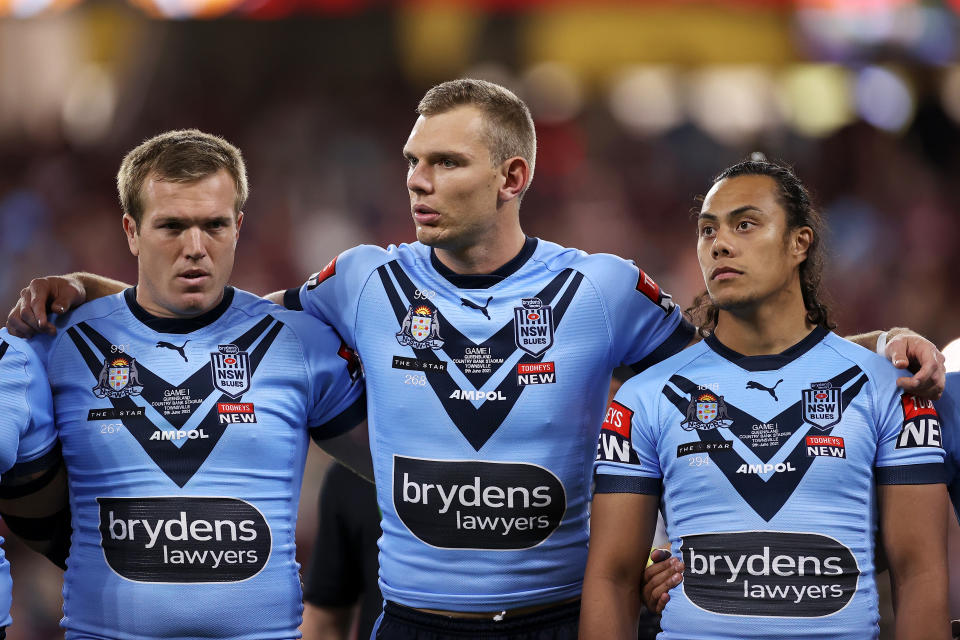 TOWNSVILLE, AUSTRALIA - JUNE 09:  Jake Trbojevic, Tom Trbojevic and Jarome Luai prepare for the anthem before game one of the 2021 State of Origin series between the New South Wales Blues and the Queensland Maroons at Queensland Country Bank Stadium on June 09, 2021 in Townsville, Australia. (Photo by Mark Kolbe/Getty Images)