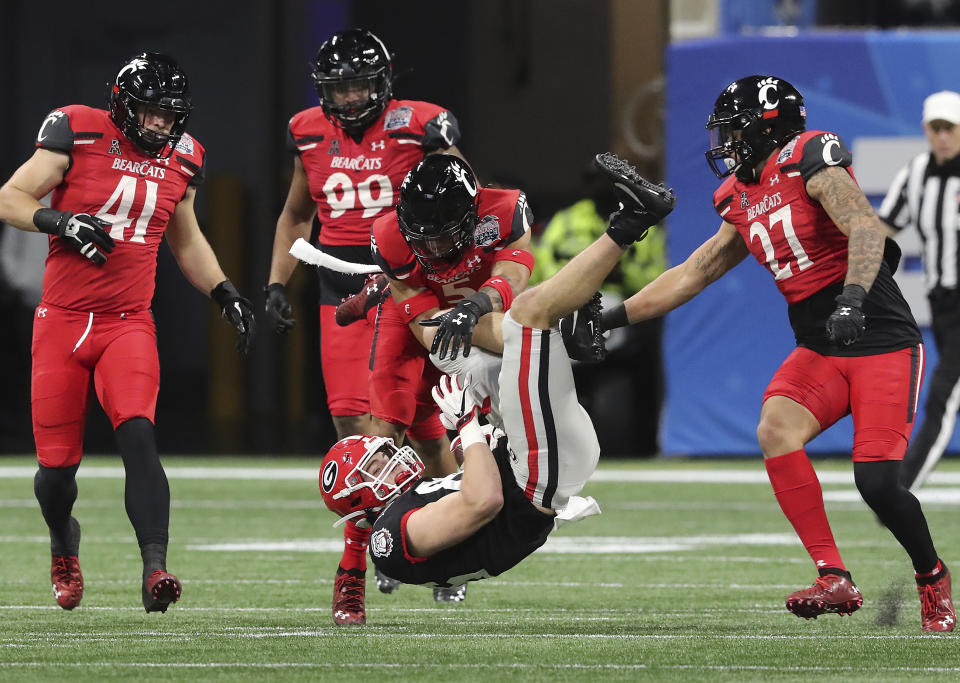 Georgia tight end John FitzPatrick is upended by Cincinnati safety Derrick Forrest after picking up a first down in the NCAA college football Peach Bowl game on Friday, Jan. 1, 2021, in Atlanta. (Curtis Compton/Atlanta Journal-Constitution via AP)