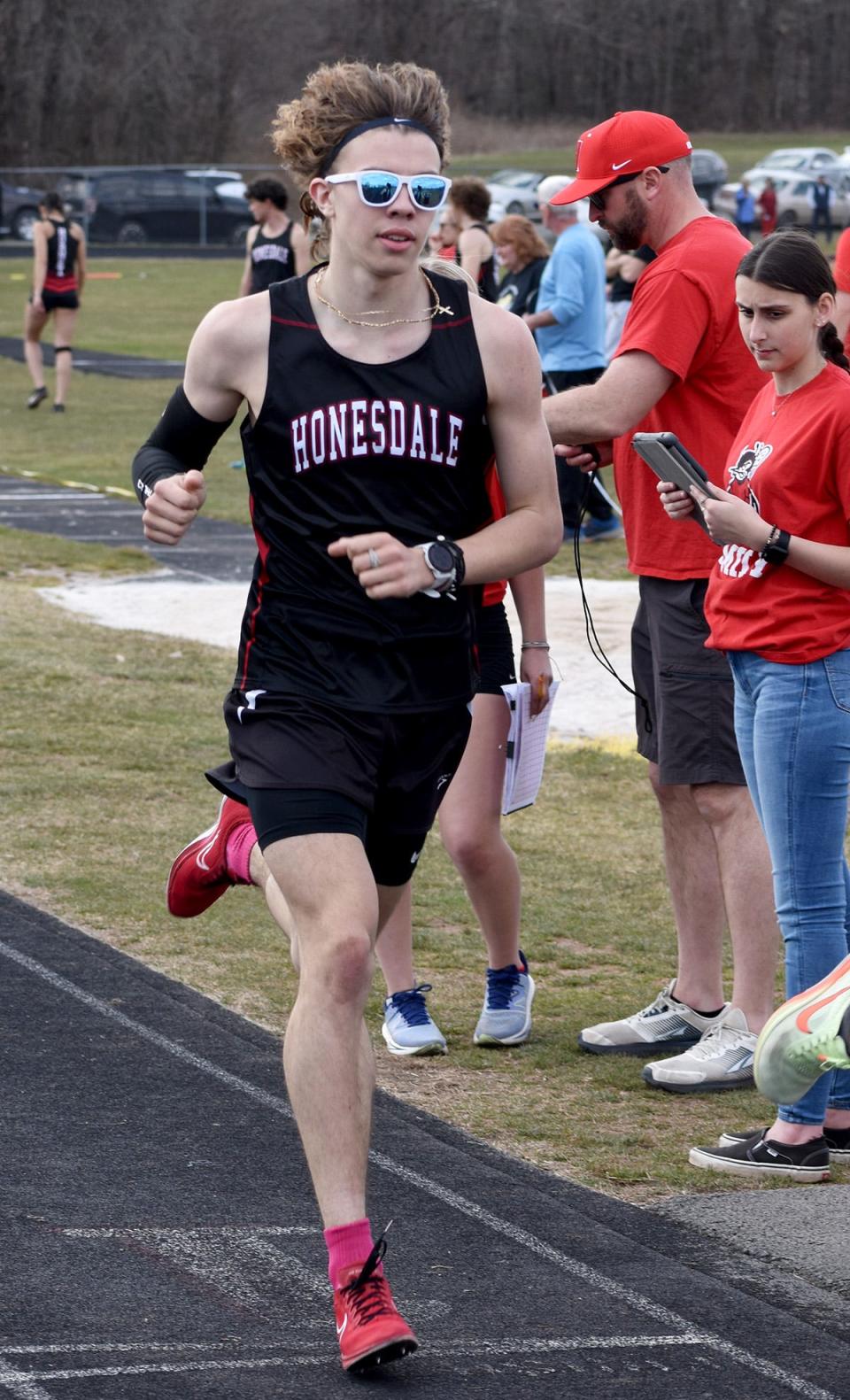 Honesdale's Aidan LaTourette cruises to victory in the 1600M during Lackawanna League track & field action against Western Wayne.