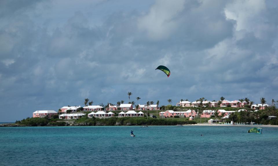 A man sailboards in the waters off Long Bay Beach in in Somerset, Bermuda on June 22, 2017.