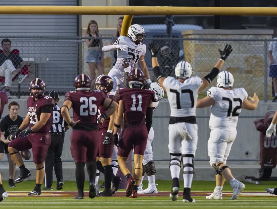 Vandegrift running back Brendan Fournier is lifted by teammates in celebration after a touchdown against Dripping Springs on Friday.