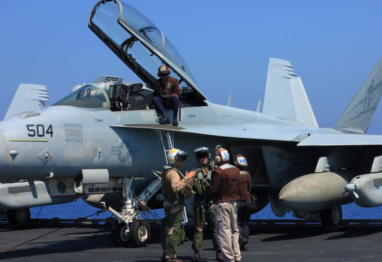 Fighter pilots and aircraft controllers prepare for daily takeoffs. 