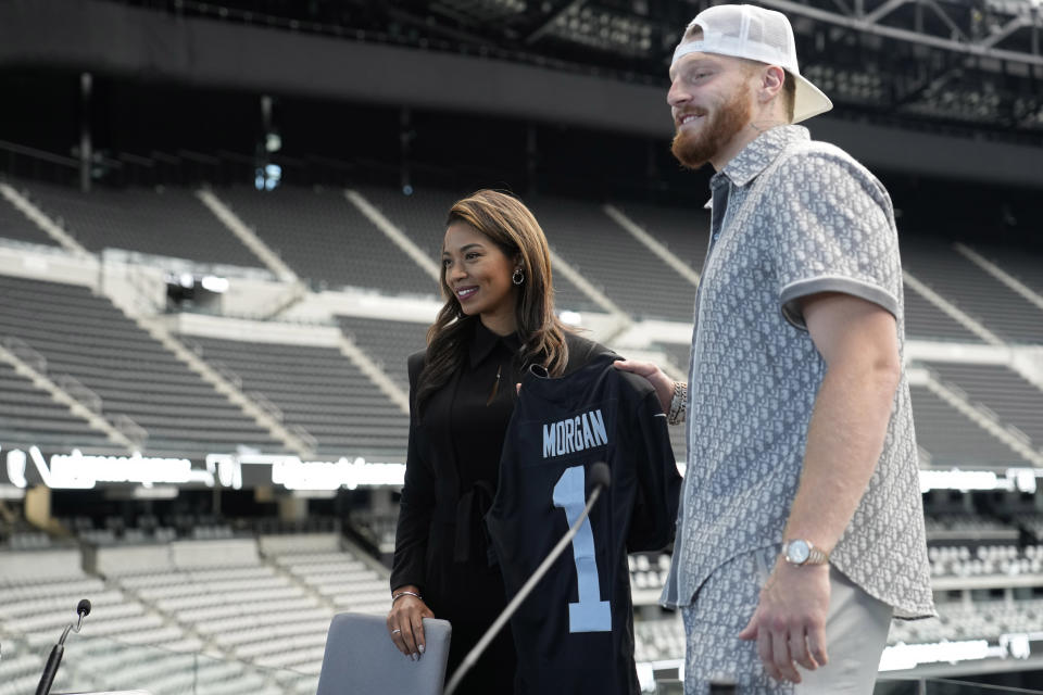 Sandra Douglass Morgan, left, poses beside Las Vegas Raiders defensive end Maxx Crosby during a news conference announcing Morgan as the new president of the Raiders NFL football team Thursday, July 7, 2022, in Las Vegas. (AP Photo/John Locher)