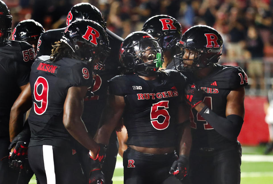 Rutgers running back Kyle Monangai (5) celebrates with wide receivers JaQuae Jackson (9) and Isaiah Washington (14) after scoring a touchdown against Temple during the second half of an NCAA college football game Saturday, Sept. 9, 2023, in Piscataway, N.J. (AP Photo/Noah K. Murray)