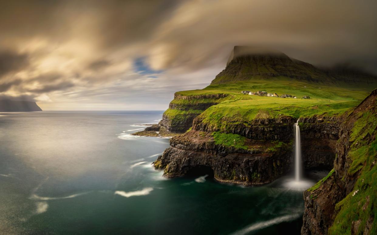 Until recently the village of Gasadalur (pictured) had no road access and getting to it meant crossing a 1,300ft peak from the adjacent settlement of Bour - This content is subject to copyright.