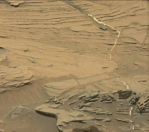 This photo by NASA's Curiosity rover shows the raw image of Mars that includes a spoon-shaped rock at the lower center. Curiosity took this photo with its Mastcam camera on Aug. 30, 2015, the rover's 1,089th day on Mars.
