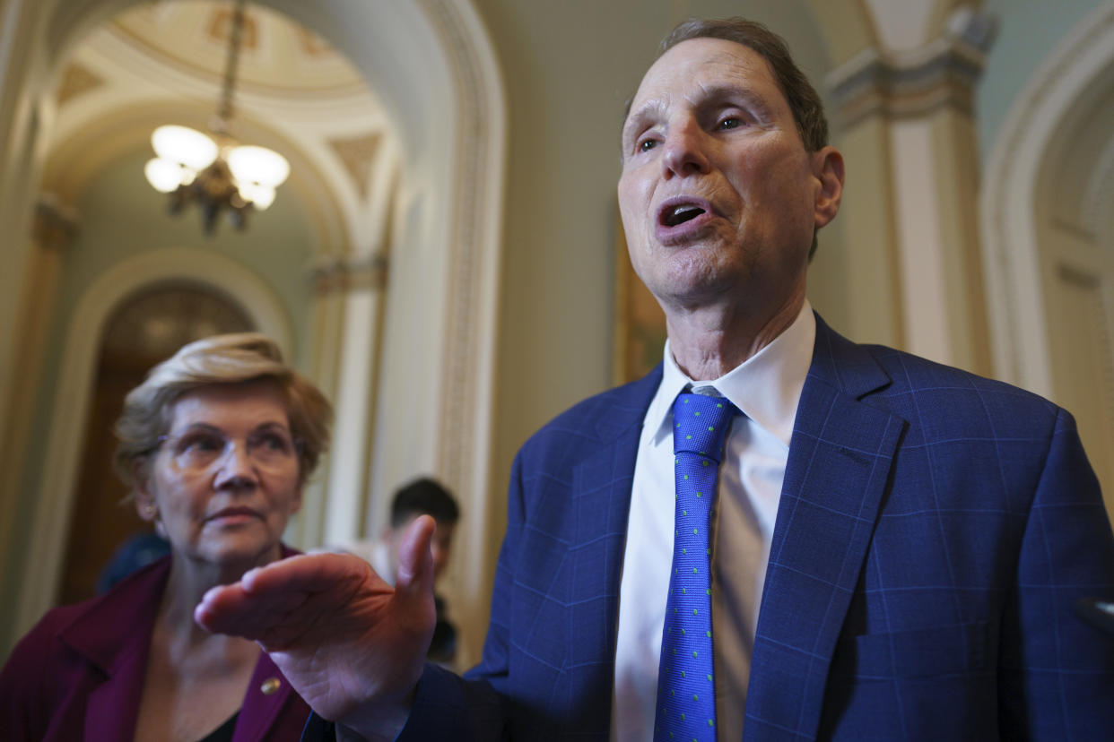 Sen. Ron Wyden, D-Ore., chair of the Senate Finance Committee, joined at left by Sen. Elizabeth Warren, D-Mass., talks about their discussions on the national debt with Senate Majority Leader Chuck Schumer, D-N.Y., at the Capitol in Washington, Wednesday, July 21, 2021. (AP Photo/J. Scott Applewhite)