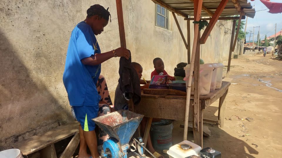 Fabian Grace awaits customers at her makeshift wooden stall in Maraba, a suburb on the fringes of Abuja, in north central Nasarawa State. - Nimi Princewill/CNN