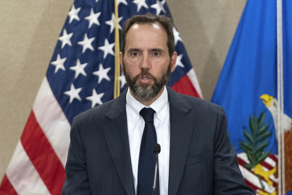 Special counsel Jack Smith stands in front of the U.S. flag.