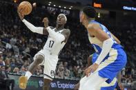 Brooklyn Nets' Dennis Schroder shoots past Milwaukee Bucks' Giannis Antetokounmpo during the first half of an NBA basketball game Thursday, March 21, 2024, in Milwaukee. (AP Photo/Morry Gash)