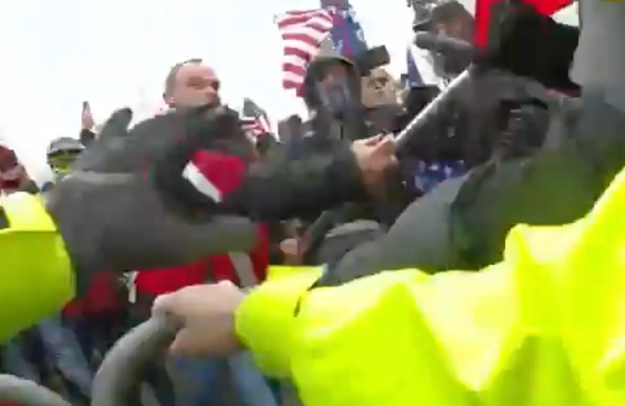 Thomas Webster, wearing a red jacket, accused of attacking police with flagpole during US Capitol attack on 6 January 2021. (DOJ)