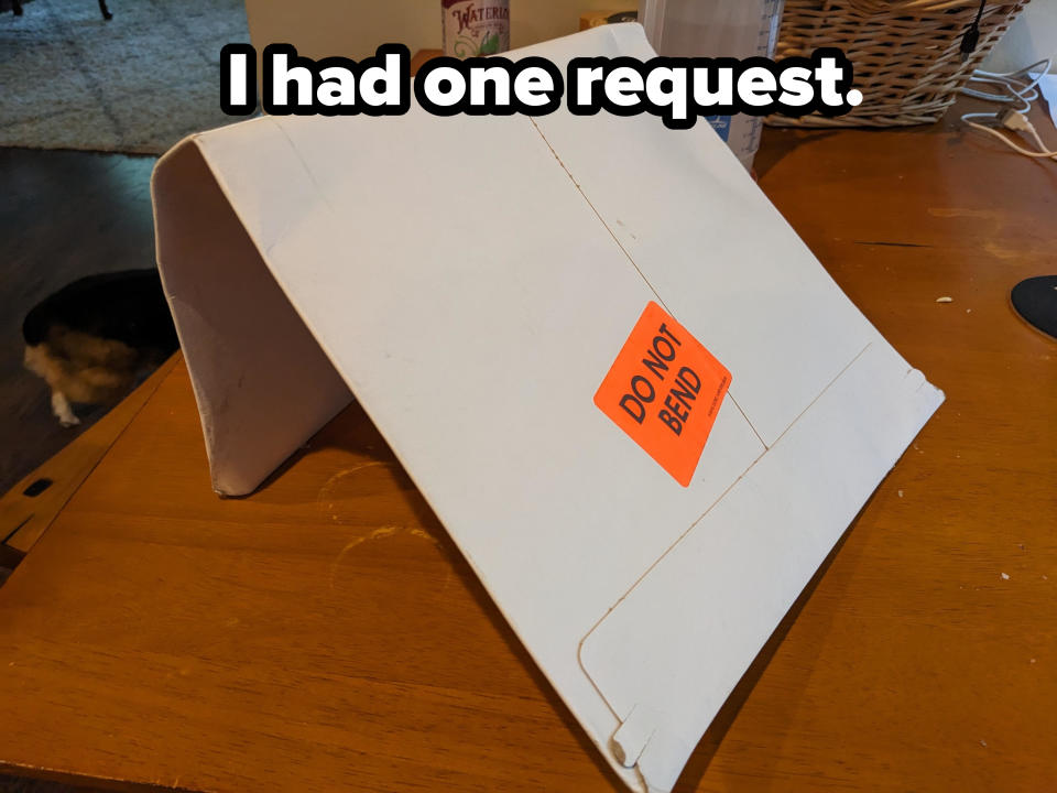 A cardboard envelope with a "DO NOT BEND" label rests on a table