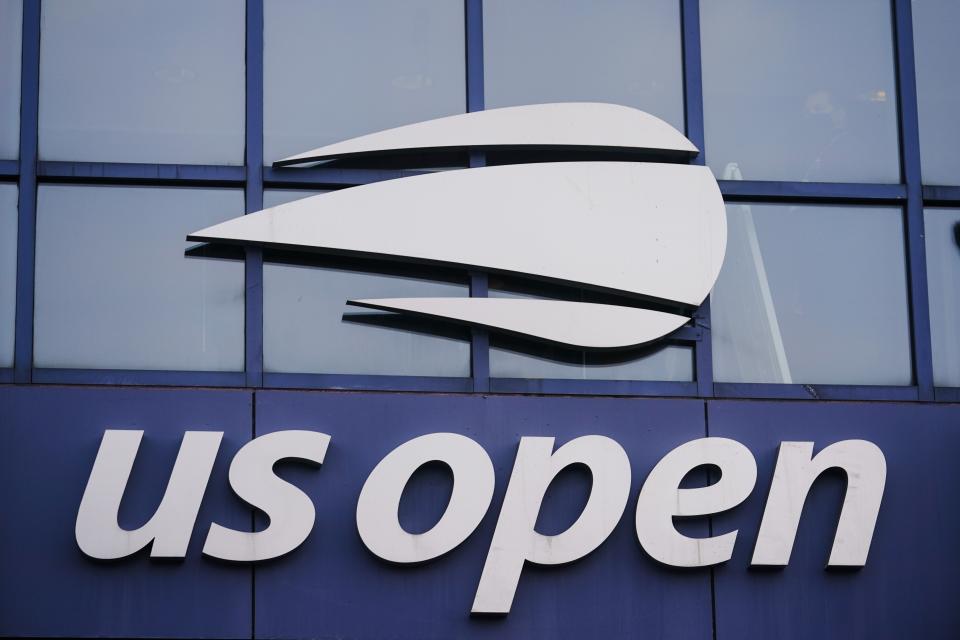 FILE - The U.S. Open logo is shown on the Arthur Ashe Stadium at the USTA Billie Jean King National Tennis Center during the Western & Southern Open tennis tournament in New York, in this Thursday, Aug. 27, 2020, file photo. The two singles champions at this year’s U.S. Open each will earn 35% less than in 2019, the last time the Grand Slam tennis tournament allowed spectators, while prize money for qualifying and the first three rounds of the main draw will rise as part of an overall increase. A year after banning fans entirely during the coronavirus pandemic and lowering prize money because of lost revenue, the U.S. Tennis Association announced Monday that it will be boosting total player compensation to a record $57.5 million, slightly more than the $57.2 million in 2019. (AP Photo/Frank Franklin II, File)