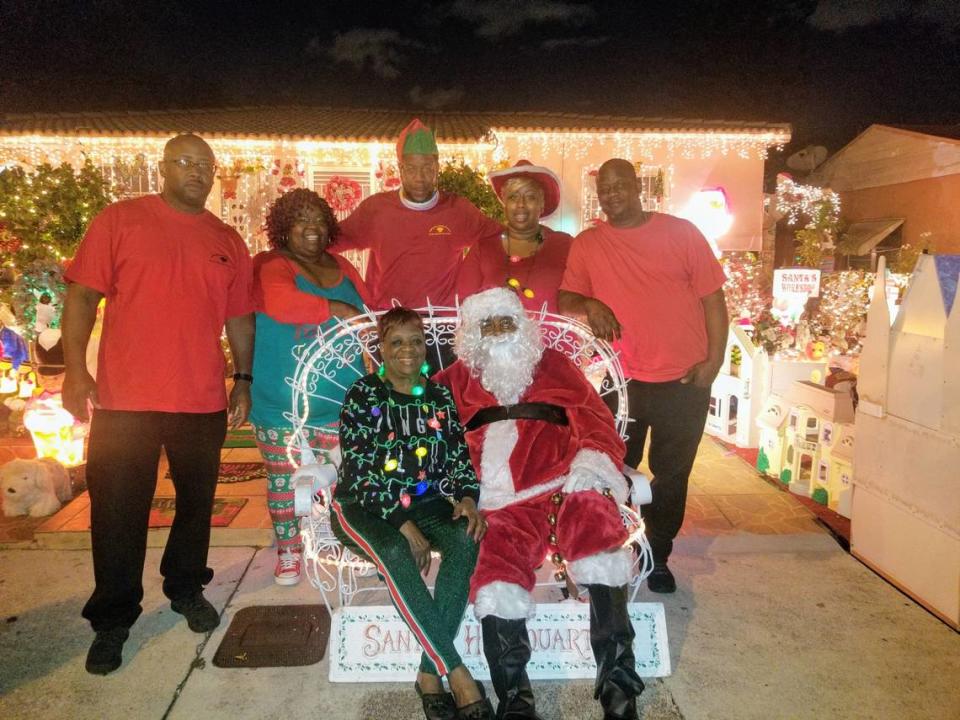 The Williams children grew up together at Santa’s Headquarters, created by their parents Ernestine and Larry Williams, in front. They are, from left, Larry Williams Jr., Shawntria Sasser, Travis Williams, Lory Celestin, and Todd Williams.
