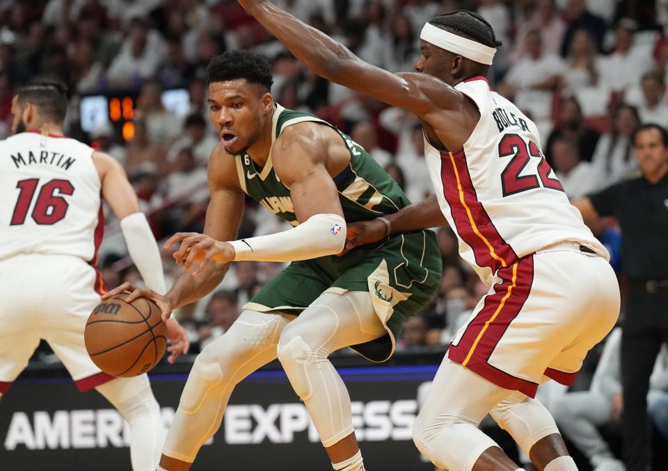 Miami Heat forward Jimmy Butler defends against Milwaukee Bucks forward Giannis Antetokounmpo.