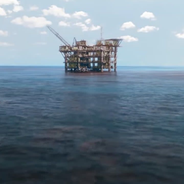 An oil rig on the water.