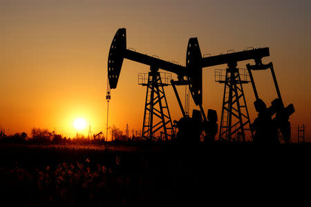 FILE PHOTO: Pumpjacks are seen against the setting sun at the Daqing oil field in Heilongjiang province, China December 7, 2018. Picture taken December 7, 2018. REUTERS/Stringer