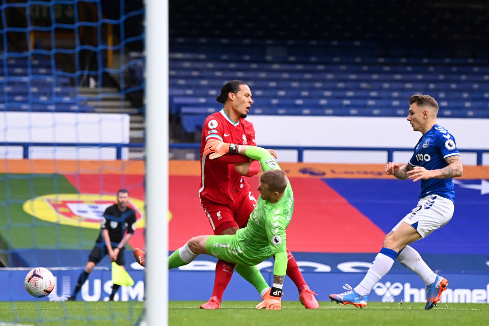 Virgil van Dijk of Liverpool is tackled by Jordan Pickford of Everton which led to the Dutchman being substituted for an injury.