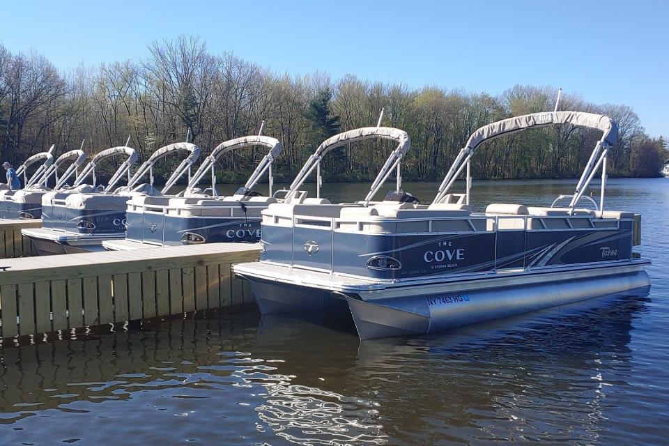 Pontoon boats docked in the water at The Cove