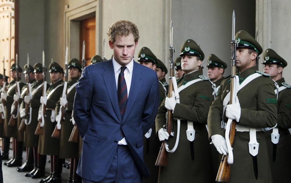 Britain's Prince Harry walks past the honour guard as he arrives to meet with Chile's President Bachelet in Santiago