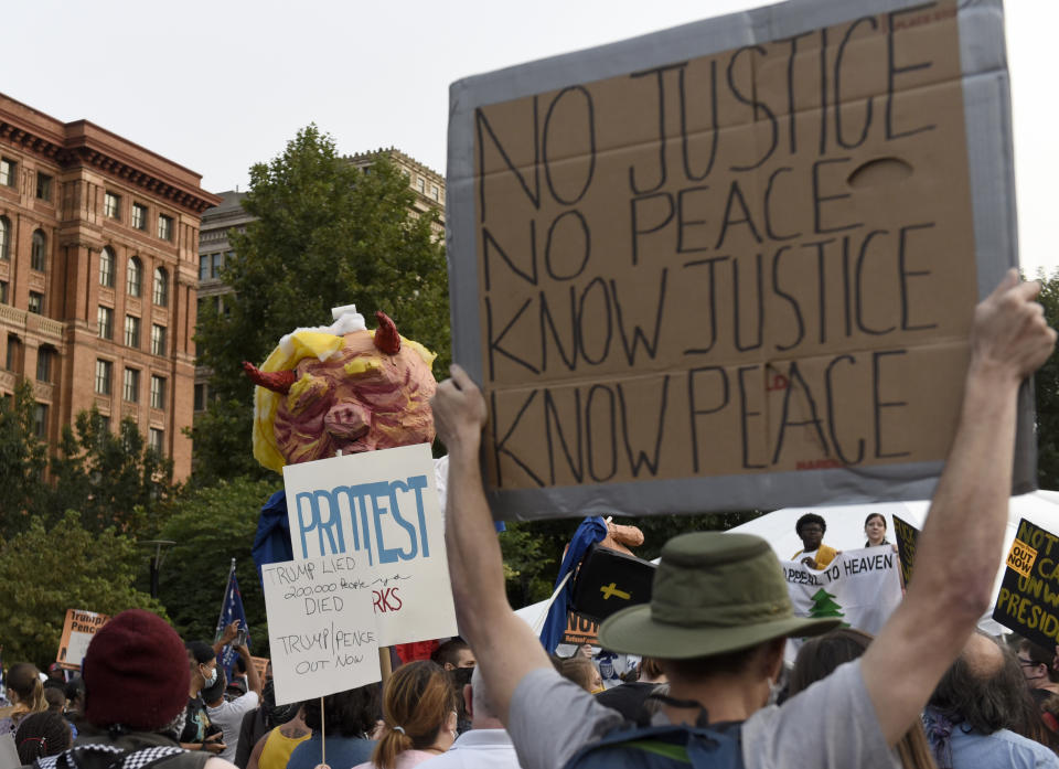 People gather at Independence Mall to protest U.S. President Donald Trump as he visits the National Constitution Center to participate in the ABC News town hall, Tuesday, Sept. 15, 2020, in Philadelphia. (AP Photo/Michael Perez)