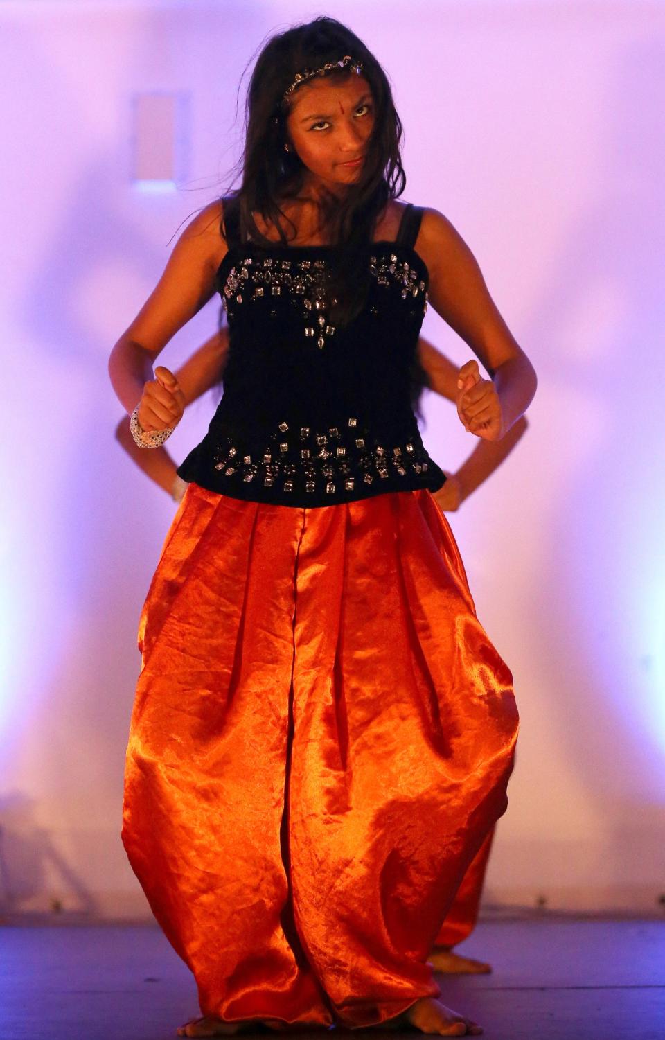 LEICESTER, UNITED KINGDOM - NOVEMBER 13: Young dancers entertain the crowds during the Hindu festival of Diwali on November 13, 2012 in Leicester, United Kingdom. Up to 35,000 people attended the Diwali festival of light in Leicester's Golden Mile in the heart of the city's asian community. The festival is an opportunity for Hindus to honour Lakshmi, the goddess of wealth and other gods. Leicester's celebrations are one of the biggest in the world outside India. Sikhs and Jains also celebrate Diwali. (Photo by Christopher Furlong/Getty Images)