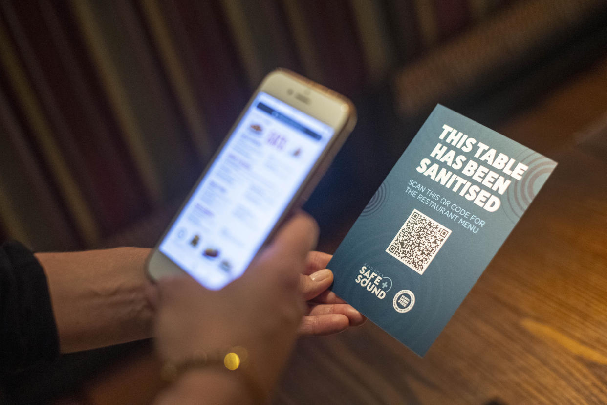 A QR code opens a digital restaurant menu to replace a hard copy on a table at the Hard Rock Cafe's European flagship restaurant in Piccadilly Circus, London, as it prepares to reopen to members of the public when the lifting of further lockdown restrictions in England comes into effect on Saturday. (Photo by Victoria Jones/PA Images via Getty Images)