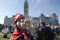 FILE PHOTO: A man smokes marijuana during an annual 4/20 rally on Parliament Hill in Ottawa, Canada, April 20, 2016. REUTERS/Chris Wattie/File Photo