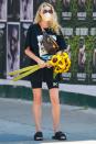 <p>Elsa Hosk makes her way through downtown N.Y.C. on Monday with a handful of sunflowers.</p>