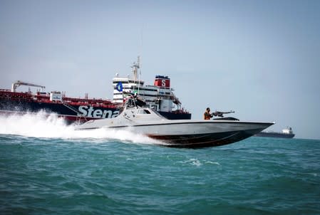 FILE PHOTO: A boat of the Iranian Revolutionary Guard sails near to Stena Impero, a British-flagged vessel owned by Stena Bulk, at an undisclosed place at sea of Bandar Abbas