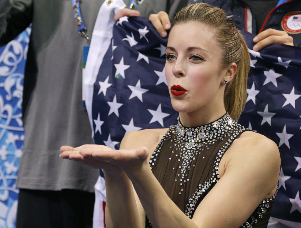 Ashley Wagner of the United States blows a kiss to spectators as she waits for her results after competing in the women's team short program figure skating competition at the Iceberg Skating Palace during the 2014 Winter Olympics, Saturday, Feb. 8, 2014, in Sochi, Russia. (AP Photo/Darron Cummings, Pool)