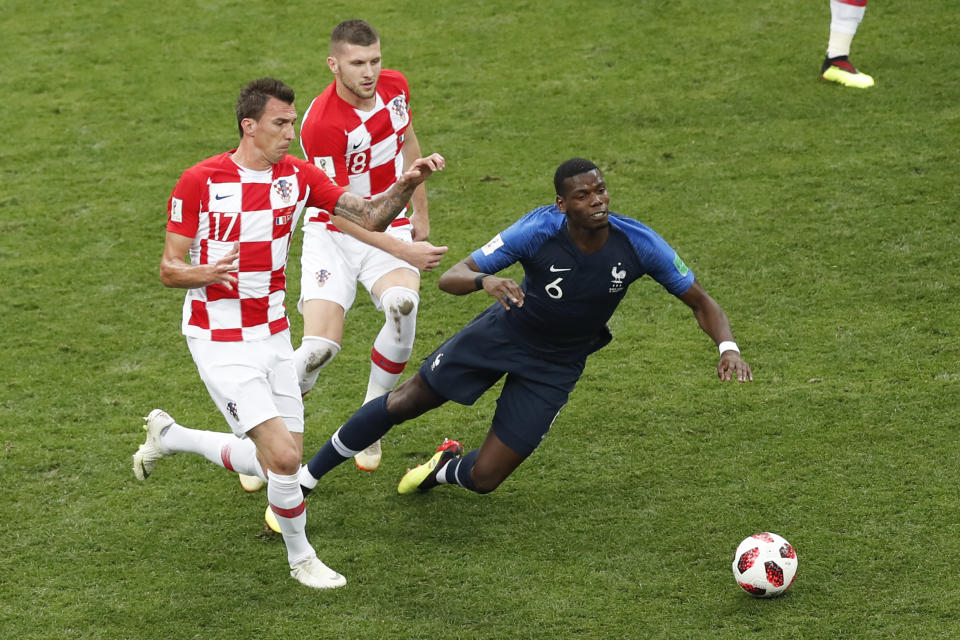France’s Paul Pogba, right, challenge for the ball with Croatia’s Mario Mandzukic, left, and Croatia’s Ante Rebic during the final match between France and Croatia at the 2018 soccer World Cup in the Luzhniki Stadium in Moscow, Russia, Sunday, July 15, 2018. (AP Photo/Rebecca Blackwell)