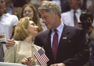 <p>Hillary and Bill Clinton look at one another as the U.S. women's team takes the 4×200 meter relay gold medal at the 1996 Atlanta Olympics. (Getty) </p>