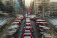 In this slow-shutter zoom effect photo, commuters backed up in traffic during the morning rush hour in Brussels, Tuesday, Dec. 10, 2019. The Belgium capital regularly experiences pollution alert warnings. (AP Photo/Francisco Seco)