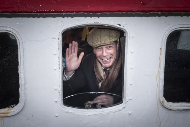 Brexit Party leader Nigel Farage looks out from a window on the Kestrel crabbing boat in Grimsby fish dock