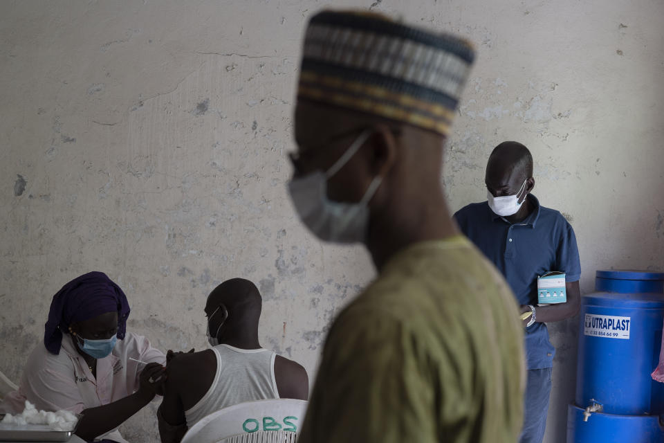 CORRECTS LOCATION A health worker administers a dose of Janssen Johnson & Johnson COVID-19 vaccine at Dakar's Medina neighborhood, Senegal, Wednesday, July 28, 2021. In the midst of a third wave of the coronavirus pandemic, with many countries on the cusp, African health officials are racing to vaccinate populations that had before been reluctant or unable to access vaccines. (AP Photo/Leo Correa)