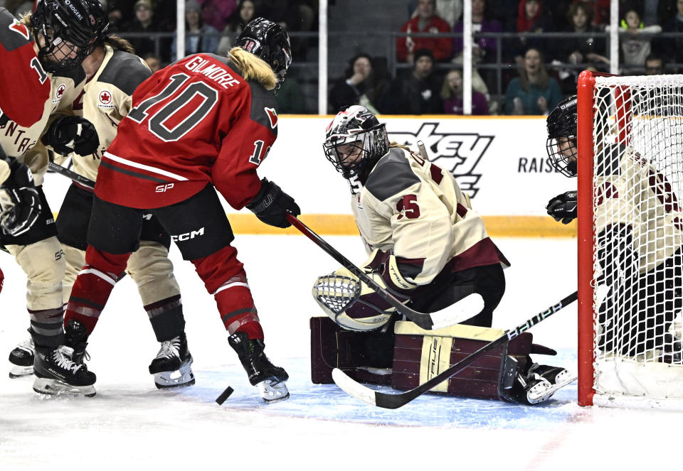 The puck bounces by the skate of Ottawa's Becca Gilmore (10) as Montreal's Ann-Renee Desbiens (35) watches, while Dominika Laskova (96) defends from inside the net during the second period of a PWHL hockey game Tuesday, Jan. 2, 2024, in Ottawa, Ontario. (Justin Tang/The Canadian Press via AP)