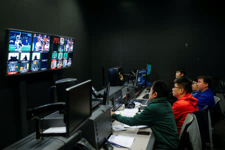 Directors and technicians monitor the broadcast of a livestream commentary of a NFL American football game in the control room of a studio of the media and gaming firm Tencent Holdings in Beijing, China, October 16, 2017. REUTERS/Thomas Peter