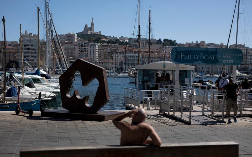Marseilles sweltered in a heatwave on Friday. Many Britons have cancelled trips to France over the prospect of having to quarantine - AP