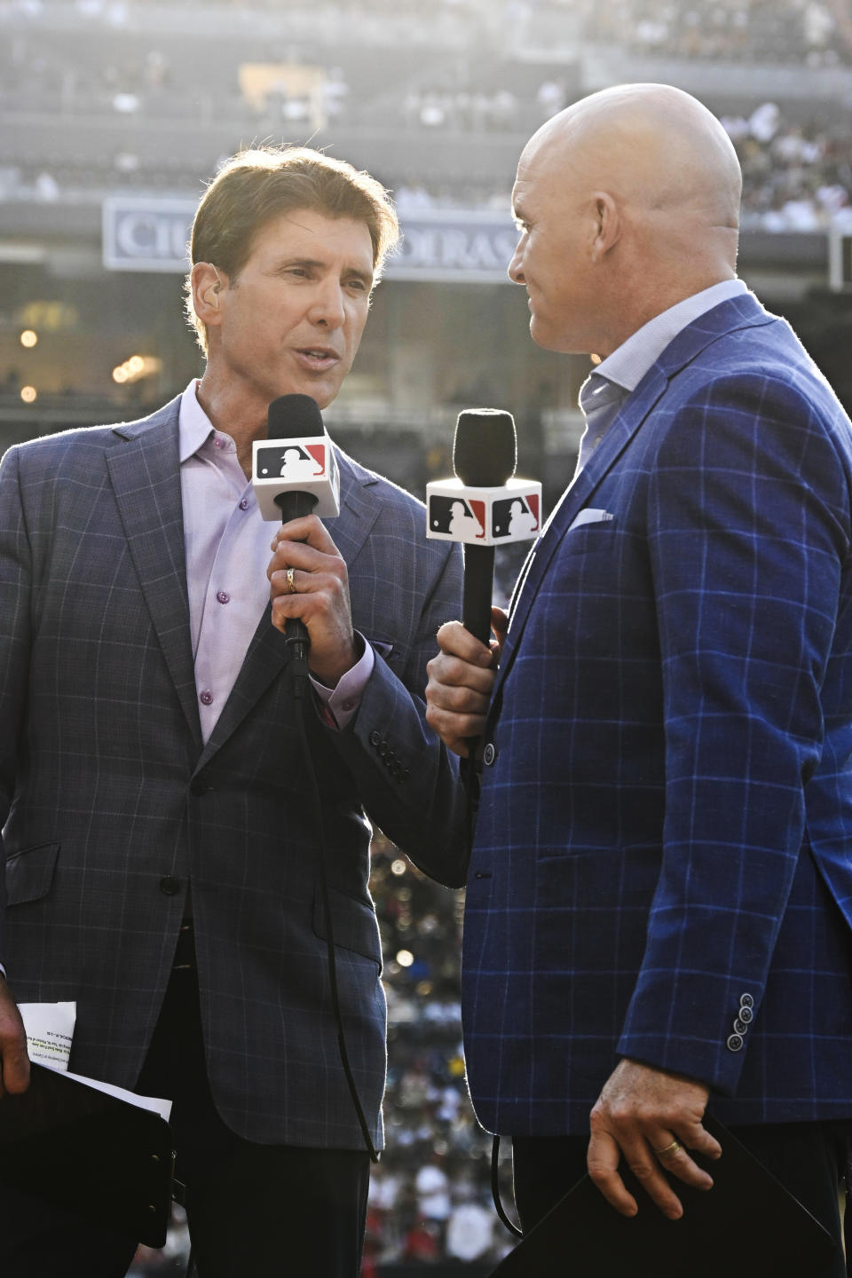 MLB broadcasters Mike Pomeranz, left, and Mark Sweeney work on a broadcast before a baseball game between the Los Angeles Angels and the San Diego Padres on Monday, July 3, 2023, in San Diego. (AP Photo/Denis Poroy)