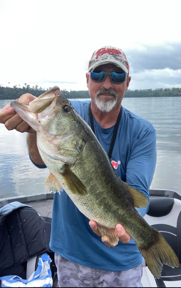 Jeff Hamm of Thomasville, GA holds up one of many Lake Seminole summer bass caught early morning fishing top water.