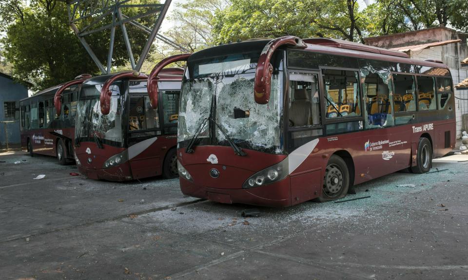 Destroyed public buses sit parked after anti-government protesters attacked them during clashes with soldiers a few blocks from the border bridge in Urena, Venezuela, Sunday, Feb. 24, 2019, on the border with Colombia where Venezuelan soldiers continue to block humanitarian aid from entering. A U.S.-backed drive to deliver foreign aid to Venezuela on Saturday met strong resistance as troops loyal to Venezuelan President Nicolas Maduro blocked the convoys at the border and fired tear gas on protesters. (AP Photo/Rodrigo Abd)