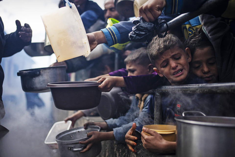 Palestinians line up for a free meal in Rafah, Gaza Strip, Friday, Feb. 16, 2024. (Fatima Shbair / AP file)